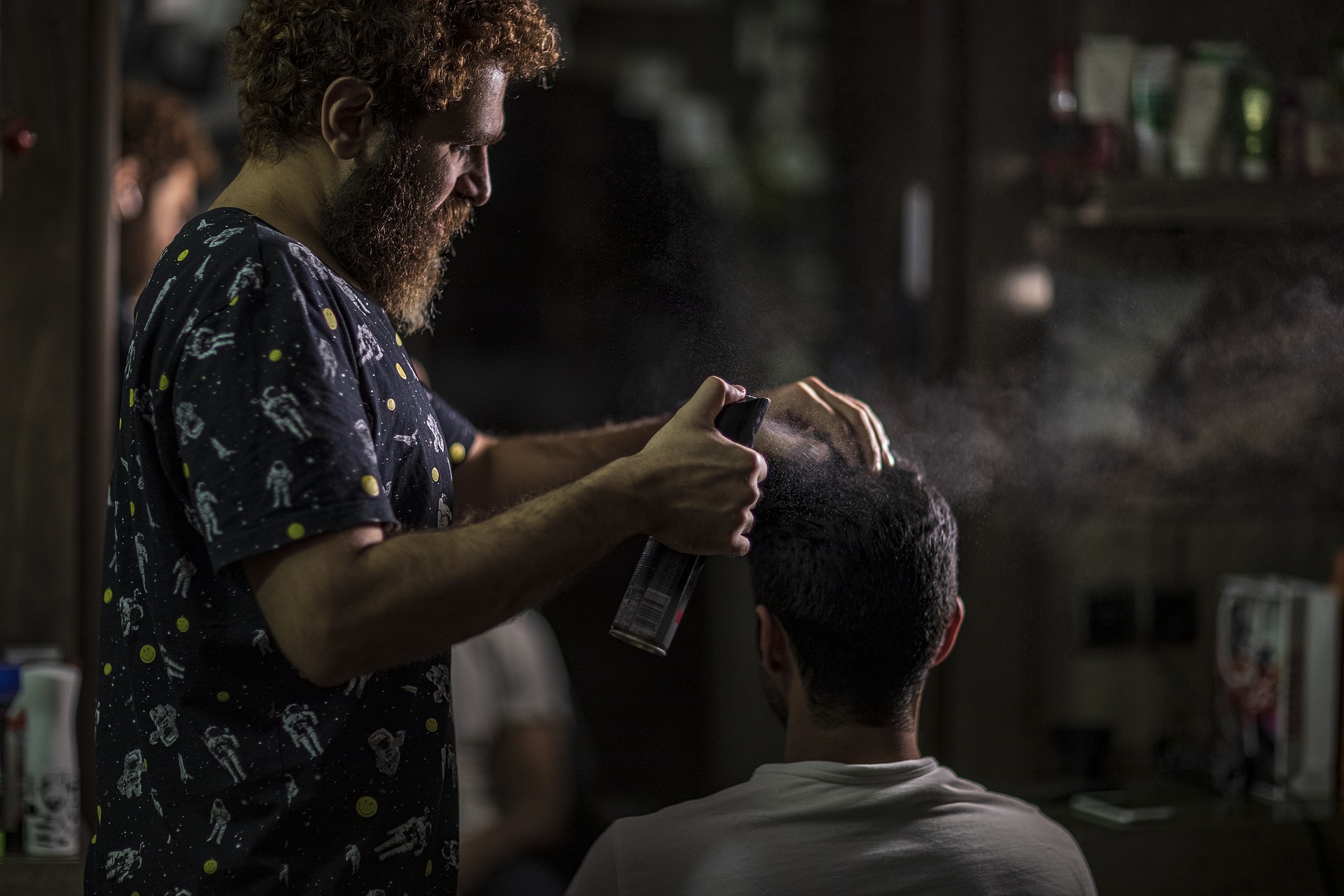 Man getting her hair styled at barbershop